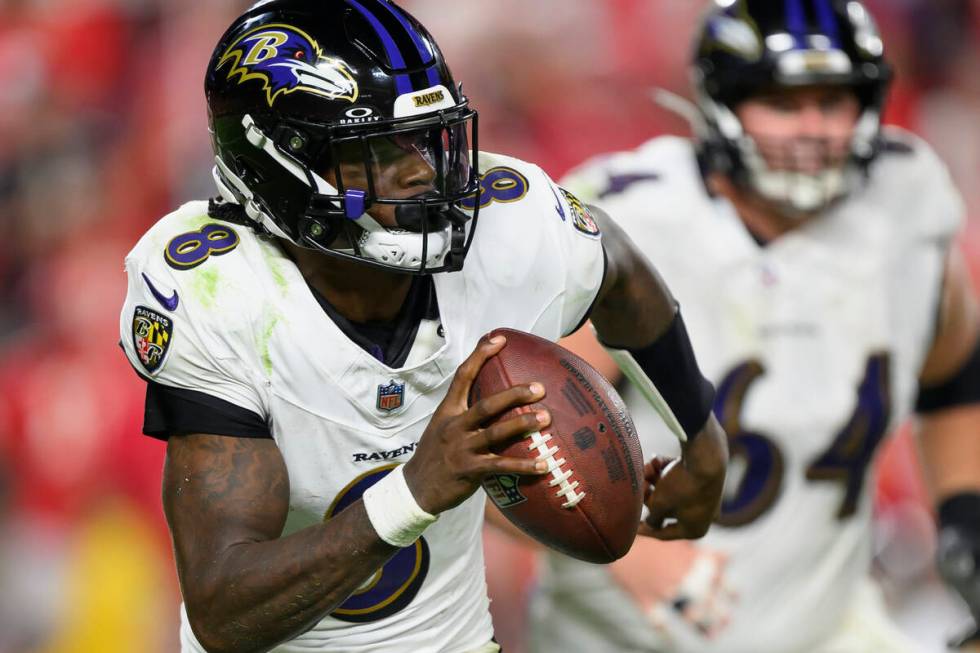 Baltimore Ravens quarterback Lamar Jackson runs the ball against the Kansas City Chiefs during ...