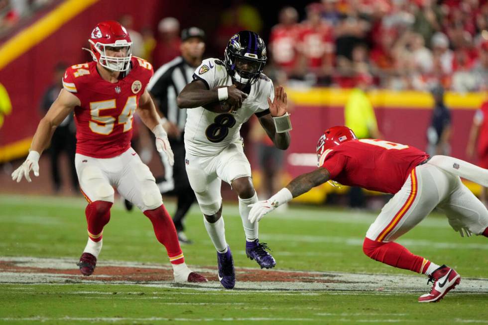 Baltimore Ravens quarterback Lamar Jackson (8) runs with the ball as Kansas City Chiefs safety ...