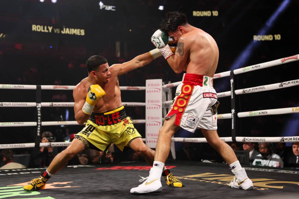 Rolly Romero, right, makes contact while Manuel Jaimes guards during a super lightweight boxing ...