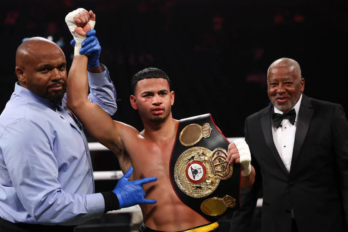 Rolly Romero poses with his belt after winning a super lightweight boxing bout against Manuel J ...