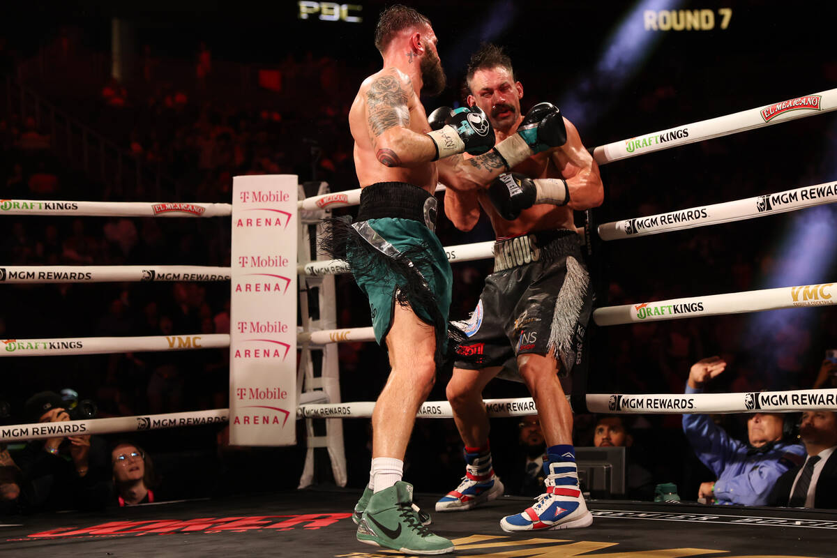 Caleb Plant gets a left on Trevor McCumby during a super middleweight title boxing bout at T-Mo ...