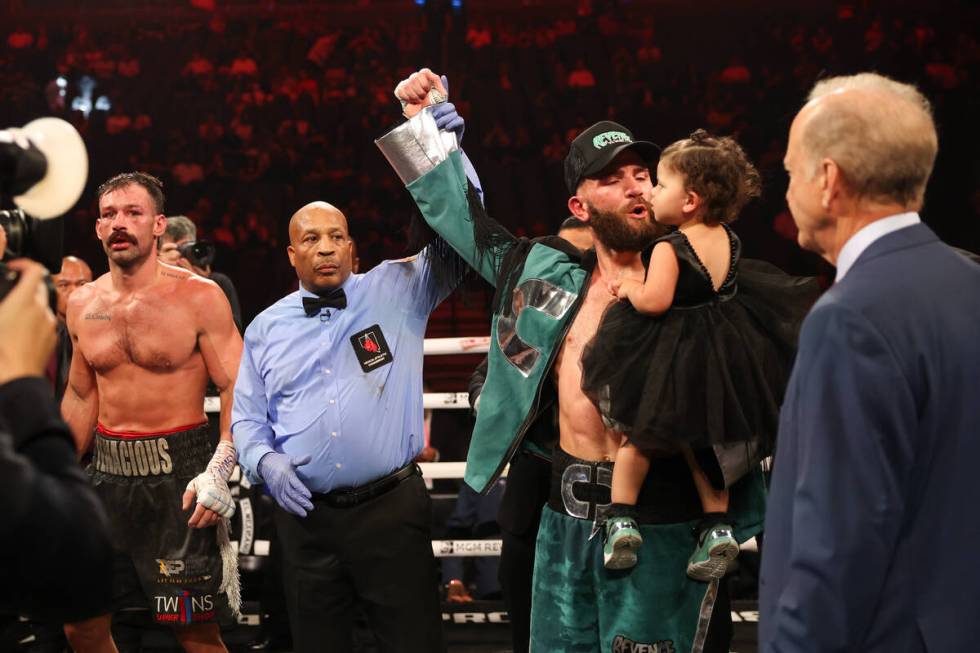 Caleb Plant, holding his daughter, celebrates his win over Trevor McCumby during a super middle ...