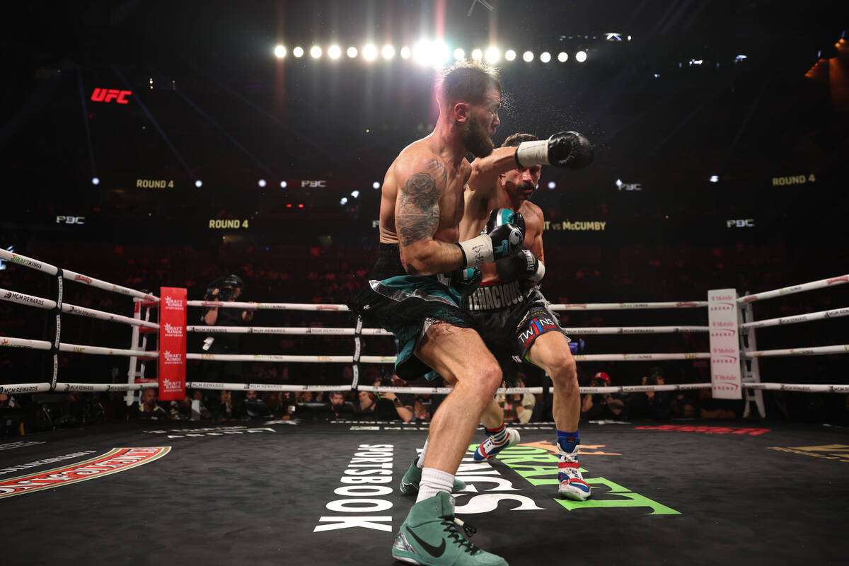 Trevor McCumby gets a right on Caleb Plant during a super middleweight title boxing bout at T-M ...