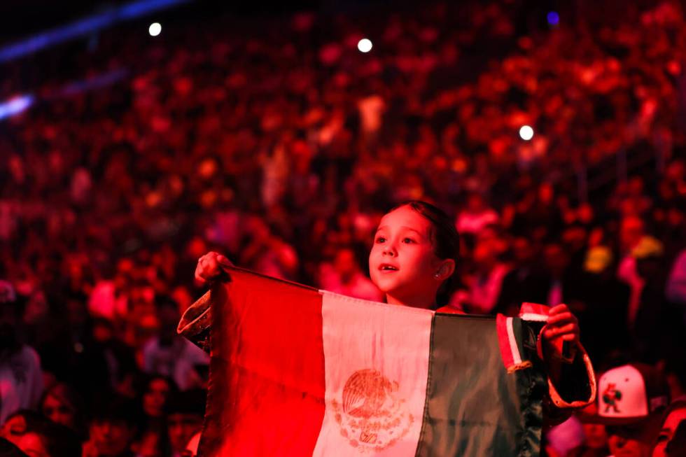 Canelo Alvarez' daughter Maria Fernanda holds up the Mexican flag before a super middleweight c ...