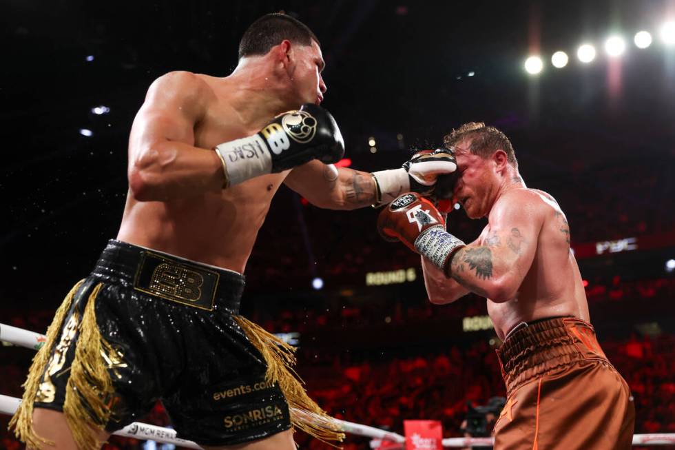 Edgar Berlanga makes contact with Canelo Alvarez during a super middleweight championship boxin ...