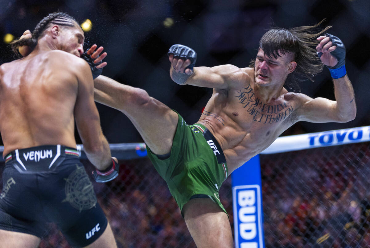 Featherweight Brian Ortega is kicked in the face by Diego Lopes in their fight during UFC 306: ...