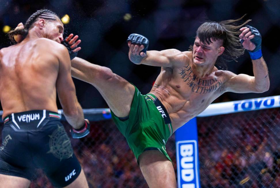 Featherweight Brian Ortega is kicked in the face by Diego Lopes in their fight during UFC 306: ...