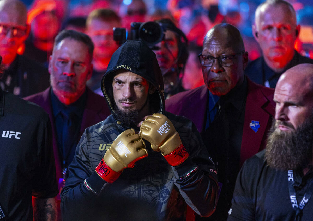 Sean O'Malley arrives to face Merab Dvalishvili above him in their bantamweight title fight dur ...