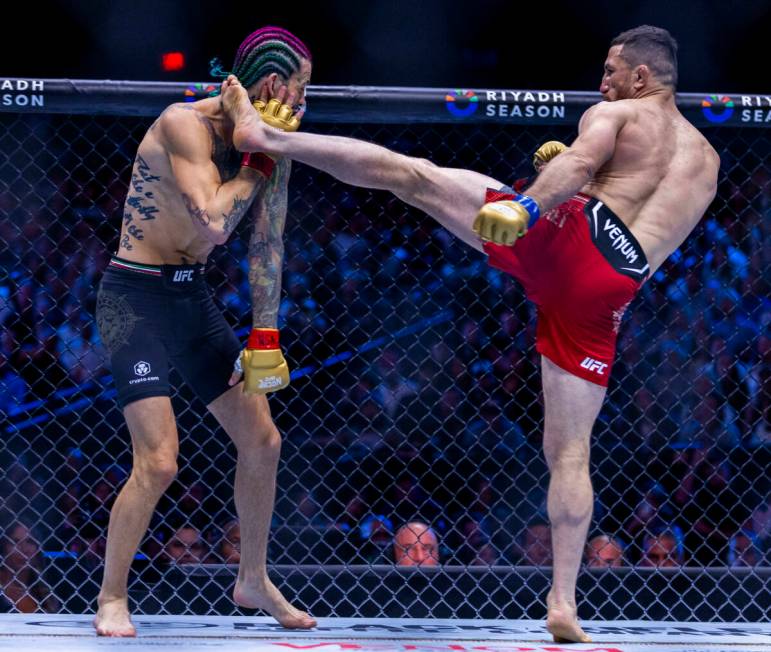 Sean O'Malley takes a kick to the face from Merab Dvalishvili in their bantamweight title fight ...