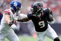 Houston Texans tight end Brevin Jordan (9) catches a pass for a first down before being stopped ...