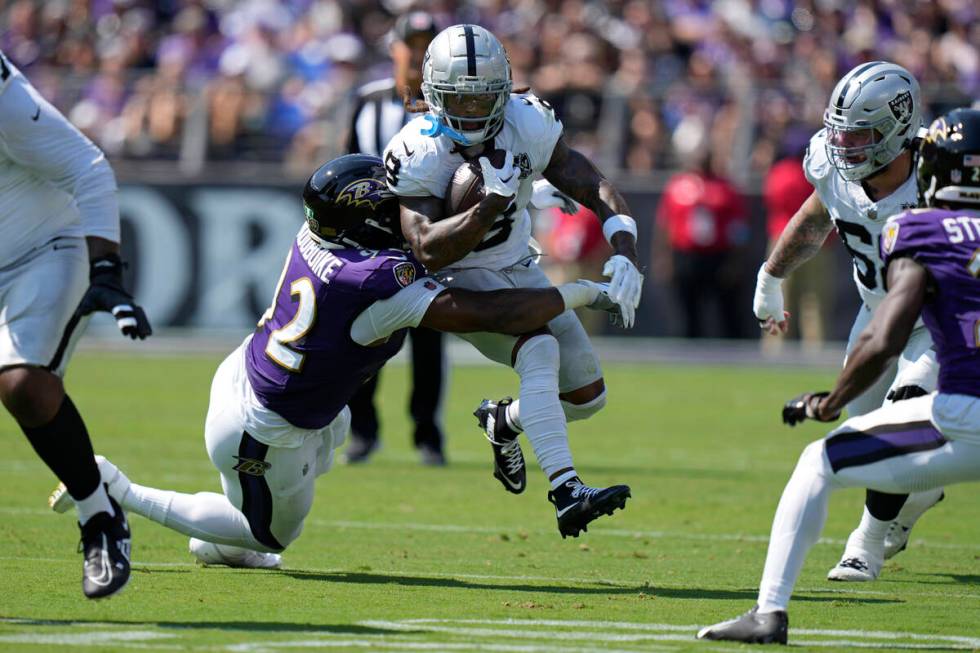 Baltimore Ravens defensive tackle Nnamdi Madubuike (92) tackles Las Vegas Raiders running back ...