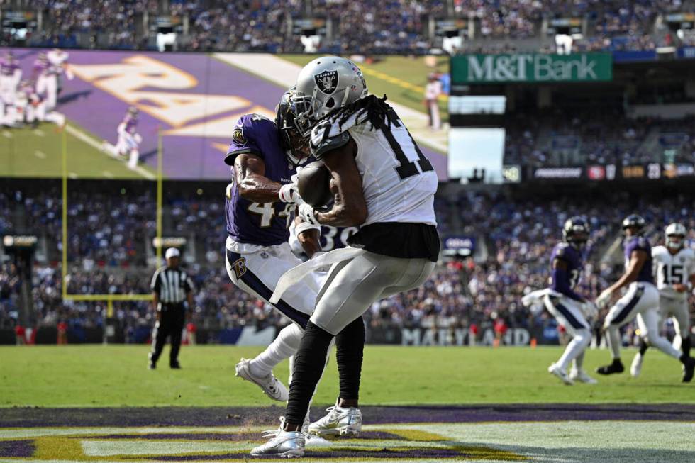 Las Vegas Raiders wide receiver Davante Adams (17) catches the ball for a touchdown against Bal ...