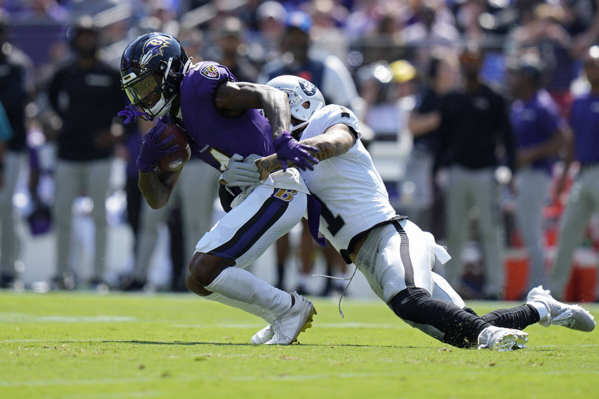 Las Vegas Raiders safety Marcus Epps (1) tackles Baltimore Ravens wide receiver Zay Flowers (4) ...