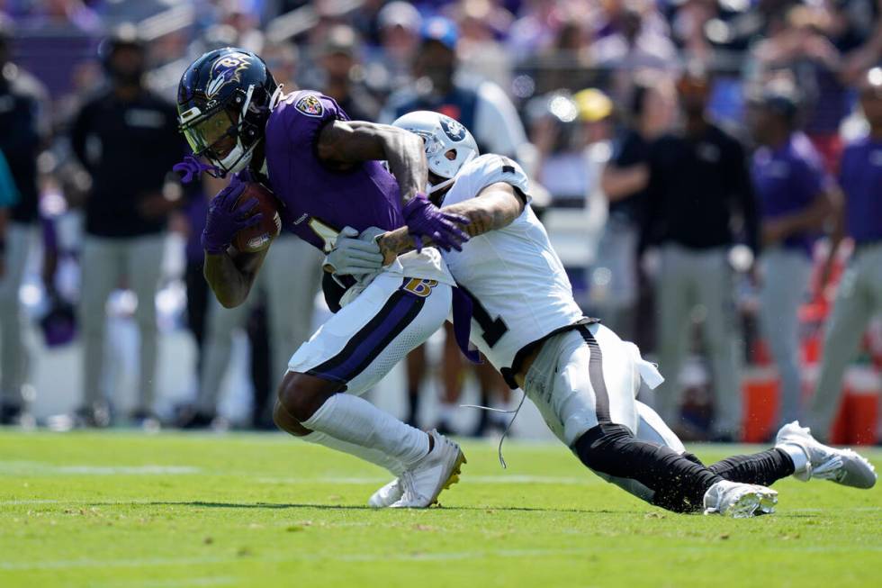 Las Vegas Raiders safety Marcus Epps (1) tackles Baltimore Ravens wide receiver Zay Flowers (4) ...