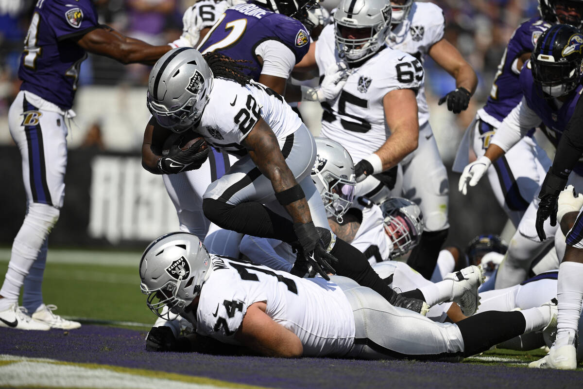 Las Vegas Raiders running back Alexander Mattison (22) scores a touchdown against the Baltimore ...