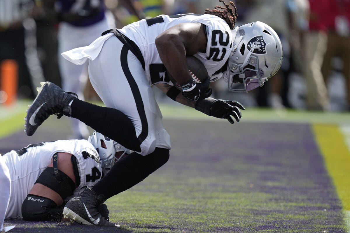 Las Vegas Raiders running back Alexander Mattison (22) scores a touchdown against the Baltimore ...