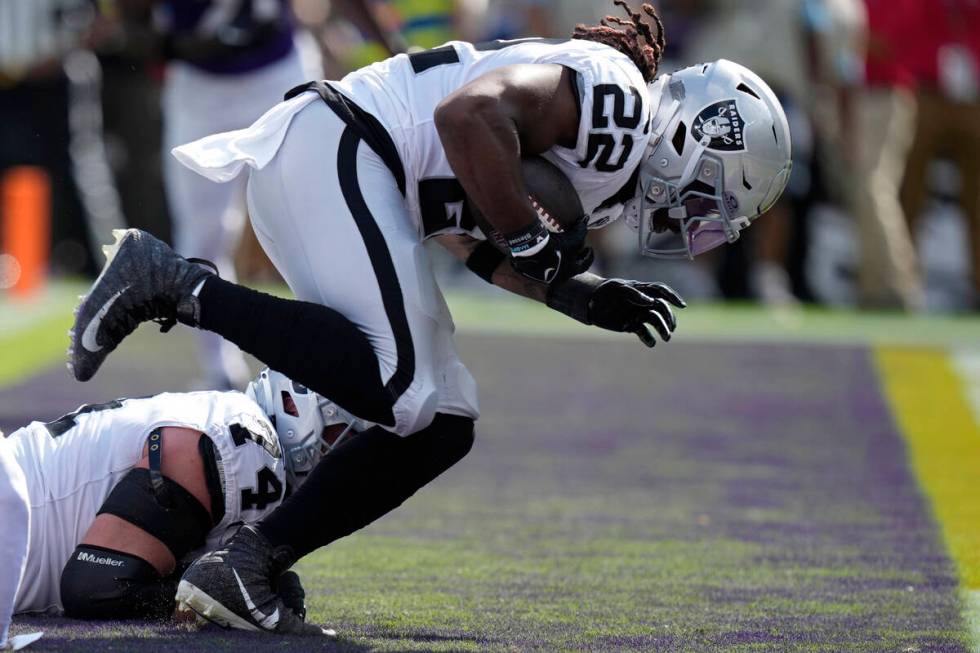 Las Vegas Raiders running back Alexander Mattison (22) scores a touchdown against the Baltimore ...