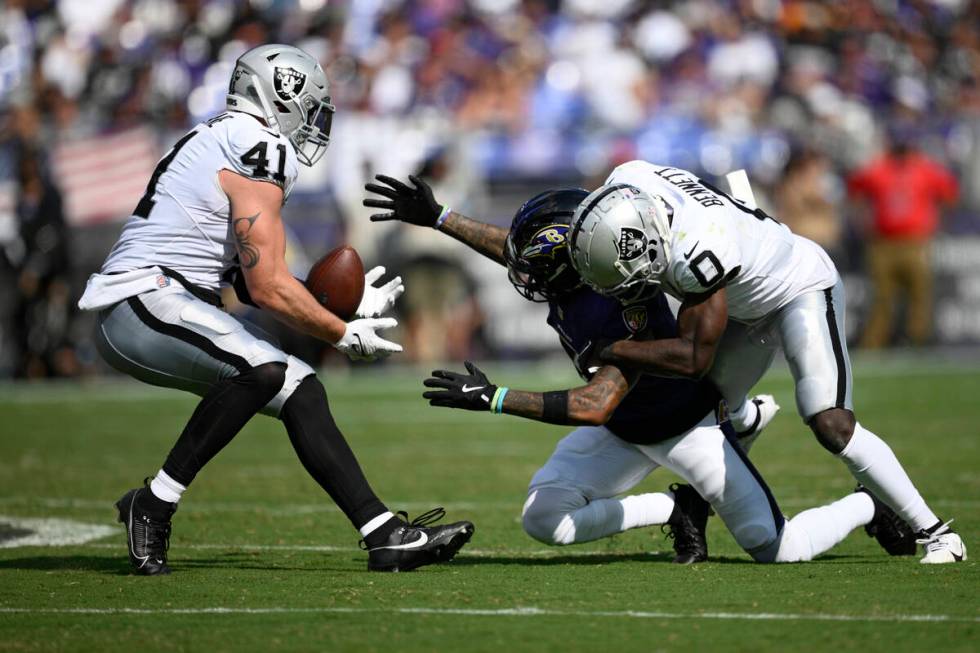 Las Vegas Raiders linebacker Robert Spillane (41) intercepts a pass intended for Baltimore Rave ...