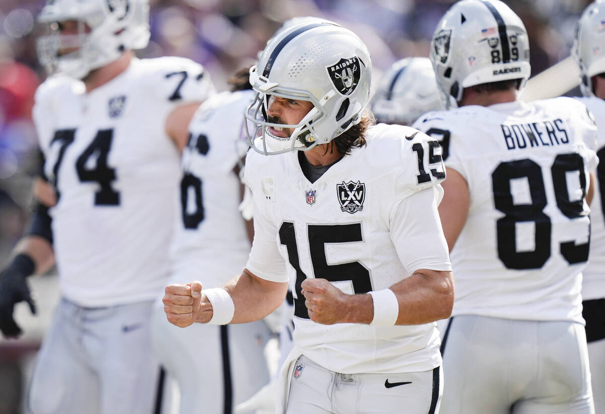 Las Vegas Raiders quarterback Gardner Minshew (15) celebrates after running back Alexander Matt ...