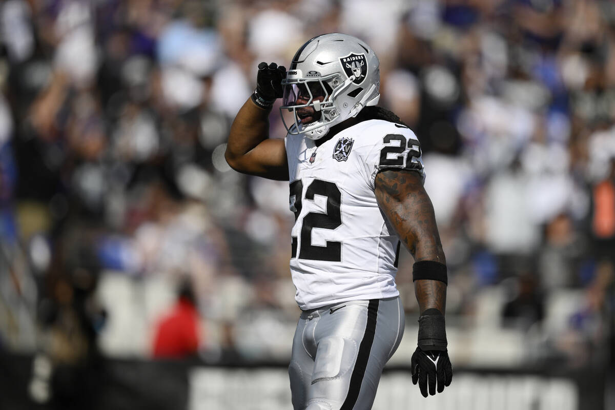 Las Vegas Raiders running back Alexander Mattison (22) celebrates after scoring a touchdown aga ...