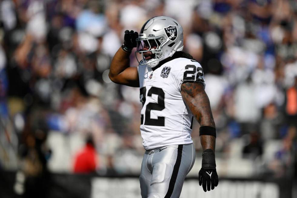 Las Vegas Raiders running back Alexander Mattison (22) celebrates after scoring a touchdown aga ...