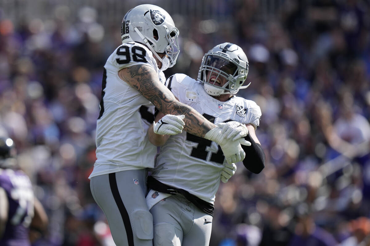 Las Vegas Raiders defensive end Maxx Crosby (98) celebrates after linebacker Robert Spillane, r ...