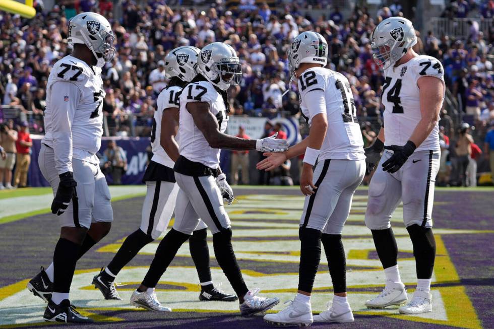 Las Vegas Raiders wide receiver Davante Adams (17) celebrates after scoring a touchdown against ...