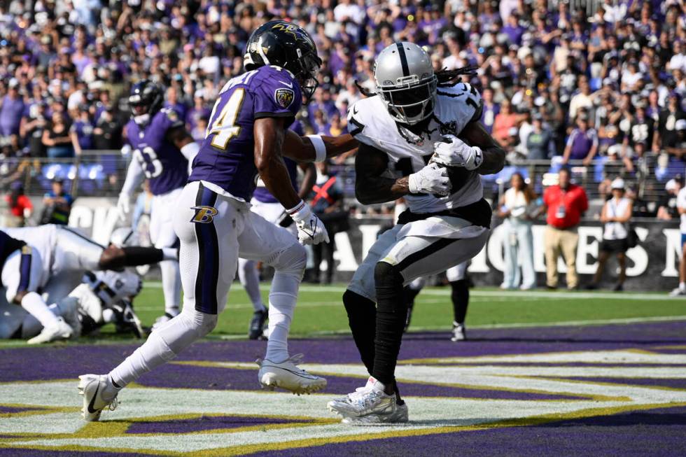 Las Vegas Raiders wide receiver Davante Adams (17) catches a touchdown pass against Baltimore R ...