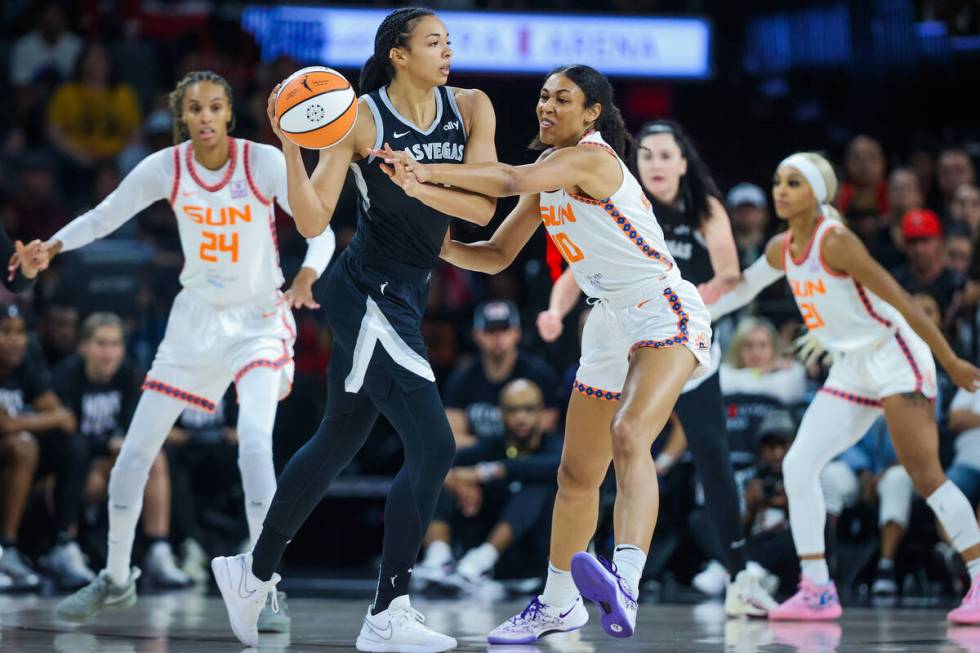 Connecticut Sun forward Olivia Nelson-Ododa (10) tries to steal the ball from Aces center Kiah ...