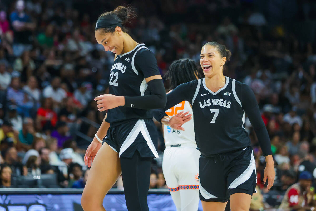 Aces center A'ja Wilson (22) and forward Alysha Clark (7) share a laugh during a time out at a ...