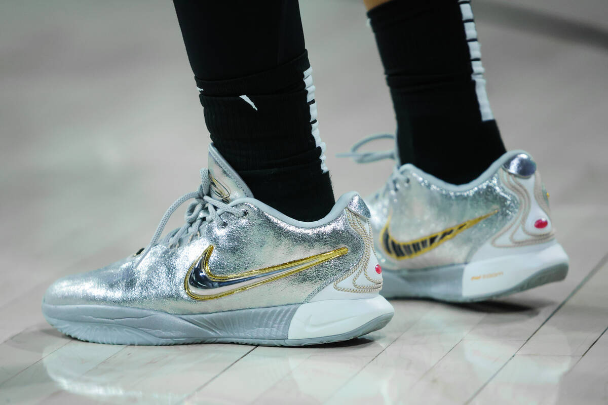 Aces center A'ja Wilson wears silver and gold sneakers during a WNBA basketball game between th ...