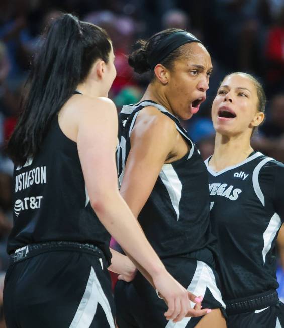 Aces center A'ja Wilson (22) gets pumped up with teammates Alysha Clark (7) and Megan Gustafson ...