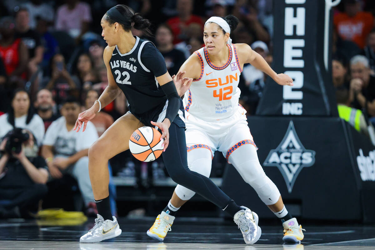 Aces center A'ja Wilson (22) dribbles the ball away from Connecticut Sun forward Brionna Jones ...