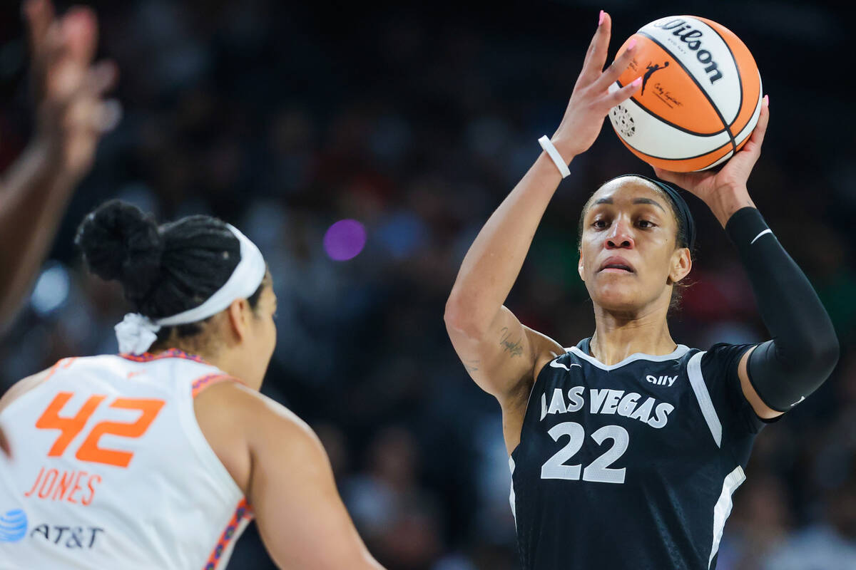 Aces center A'ja Wilson (22) looks for an open teammate to pass the ball to during a WNBA baske ...