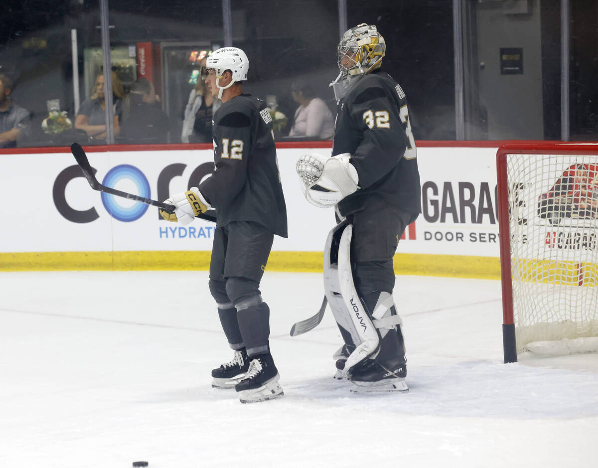 Golden Knights forward Jakub Brabenec (12) and goalie Jesper Vikman (32) wait for coach's instr ...