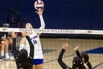 Bishop Gorman junior Charlie Wilson (16) lightly taps the ball over the net during the high sch ...