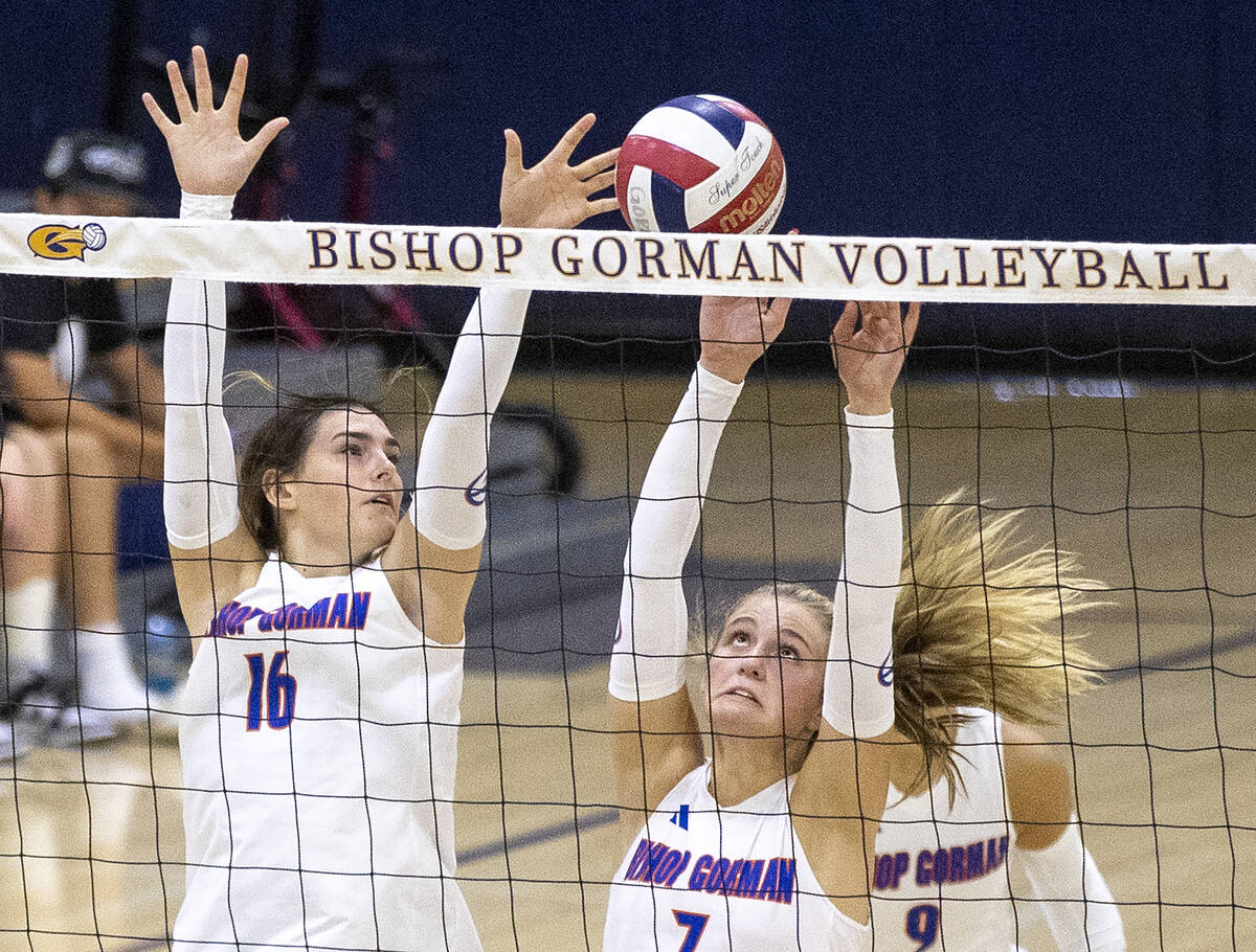 Bishop Gorman junior Charlie Wilson (16) and junior Ellie Prindl (7) attempt to block a shot du ...