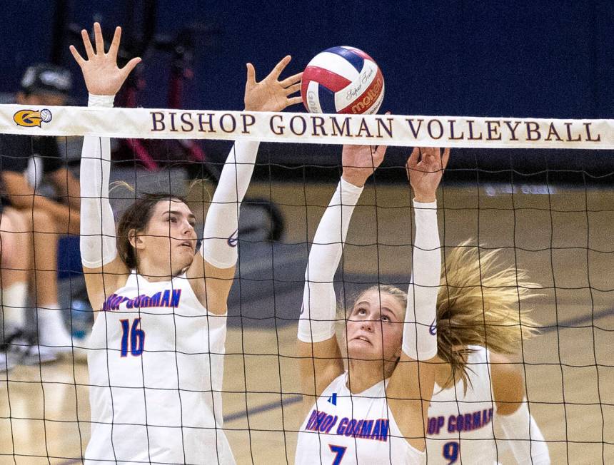 Bishop Gorman junior Charlie Wilson (16) and junior Ellie Prindl (7) attempt to block a shot du ...