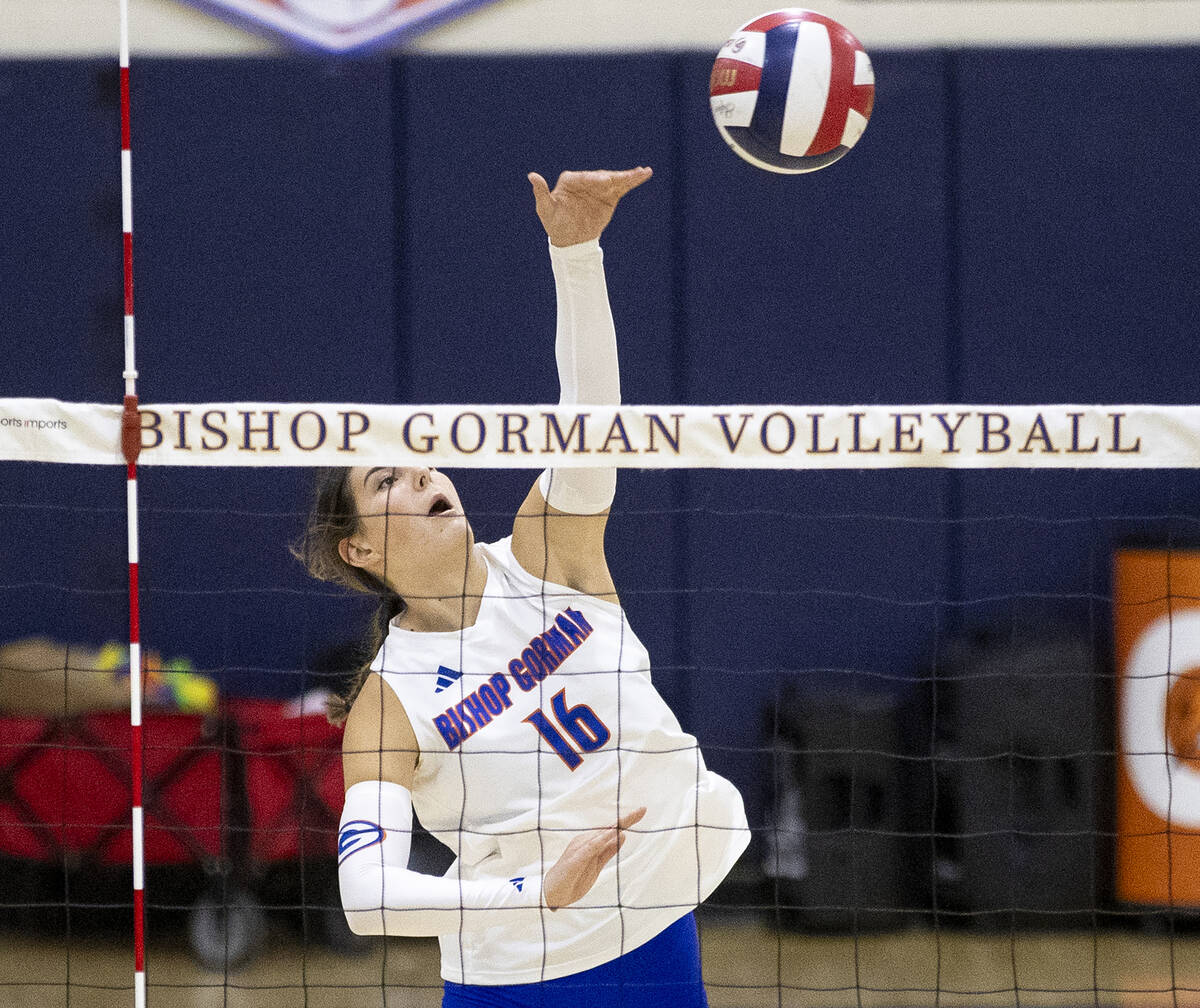 Bishop Gorman junior Charlie Wilson (16) spikes the ball during the high school volleyball game ...