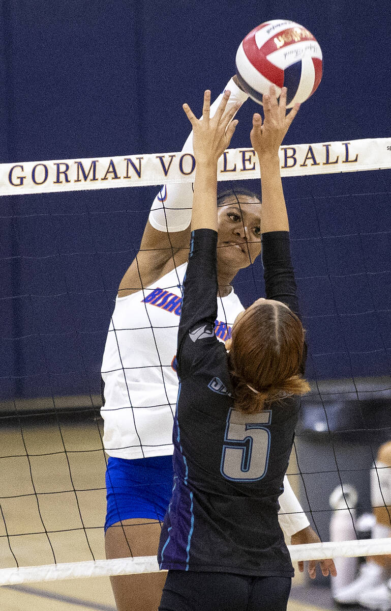 Bishop Gorman senior Carsyn Stansberry (5) attempts to spike the ball over Silverado junior Che ...