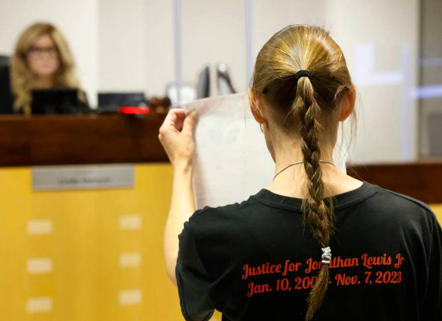 Mellisa Ready, the mother of Jonathan Lewis, wearing a "Justice for Jonathan" T-shirt, holds a ...