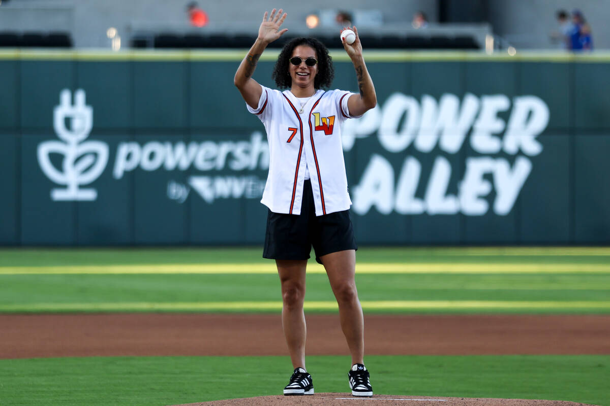 Las Vegas Aces forward Alysha Clark waves to the crowd before throwing the first pitch during a ...