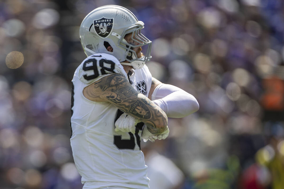 Raiders defensive end Maxx Crosby (98) poses after a sack of Baltimore Ravens quarterback Lamar ...