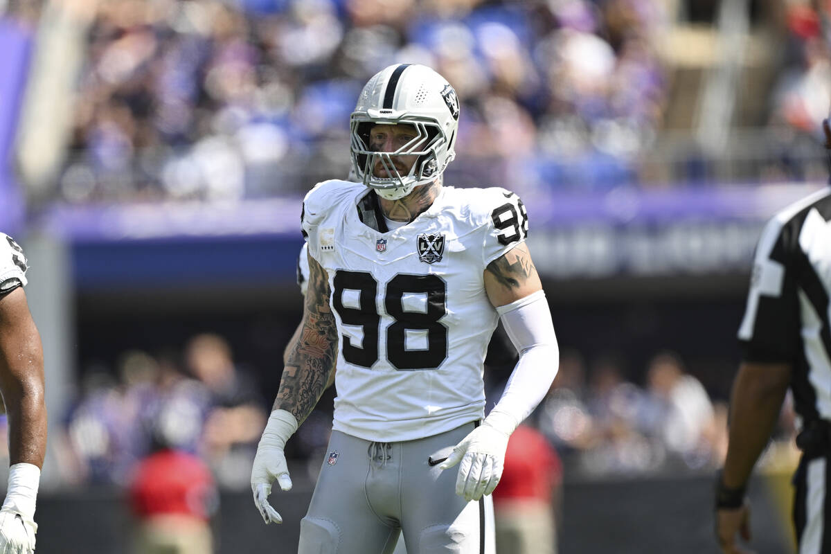 Las Vegas Raiders defensive end Maxx Crosby (98) looks on between plays during the first half o ...