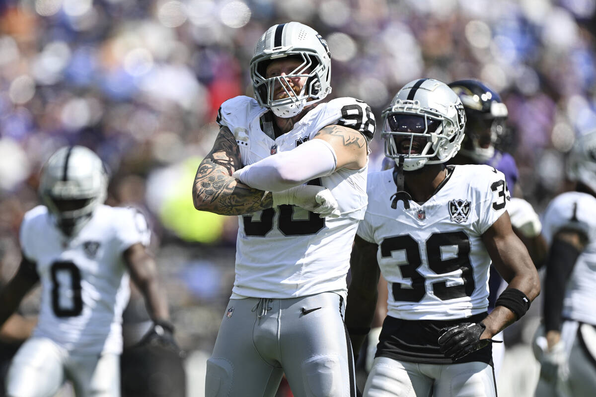 Las Vegas Raiders defensive end Maxx Crosby (98) celebrates a sack of Baltimore Ravens quarterb ...