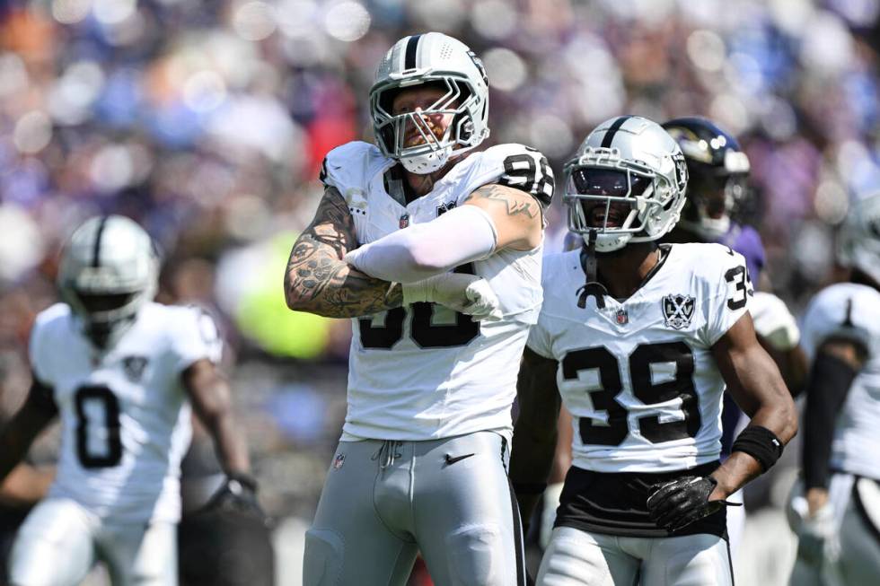 Las Vegas Raiders defensive end Maxx Crosby (98) celebrates a sack of Baltimore Ravens quarterb ...