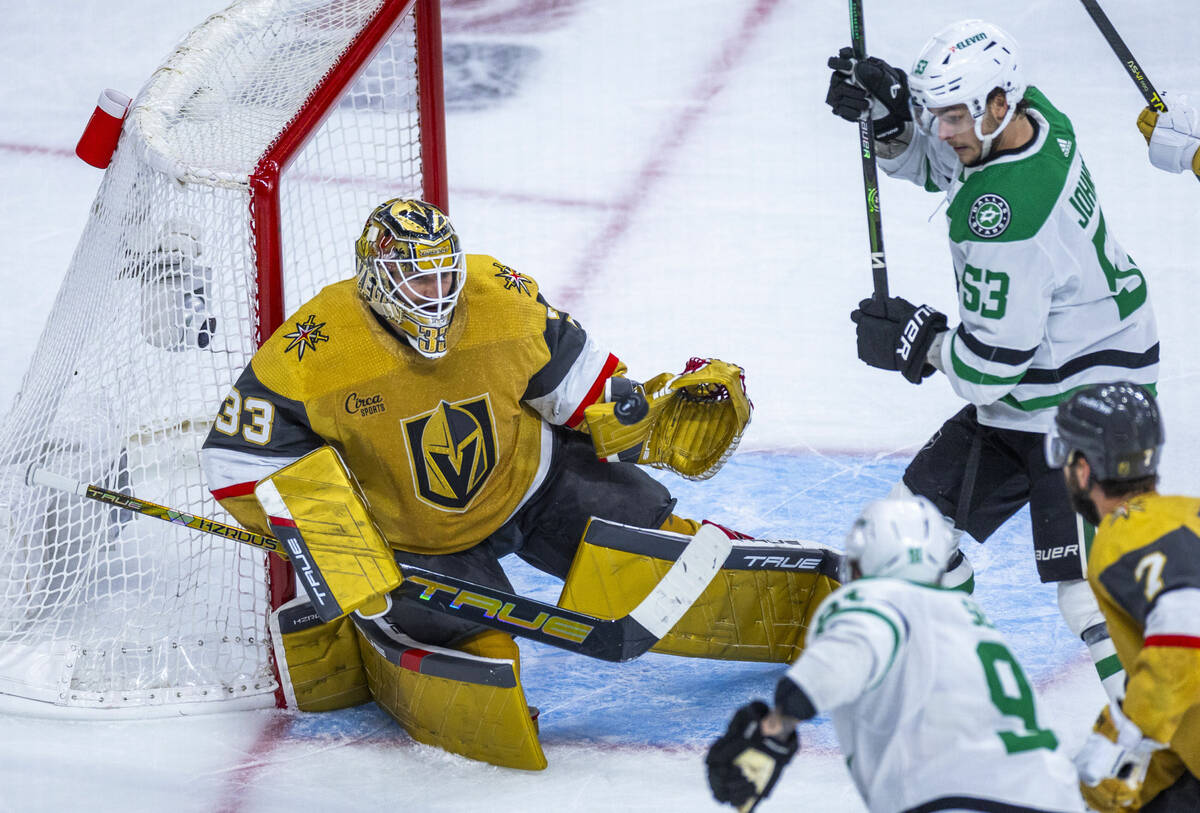 Golden Knights goaltender Adin Hill (33) makes save close to Dallas Stars center Wyatt Johnston ...