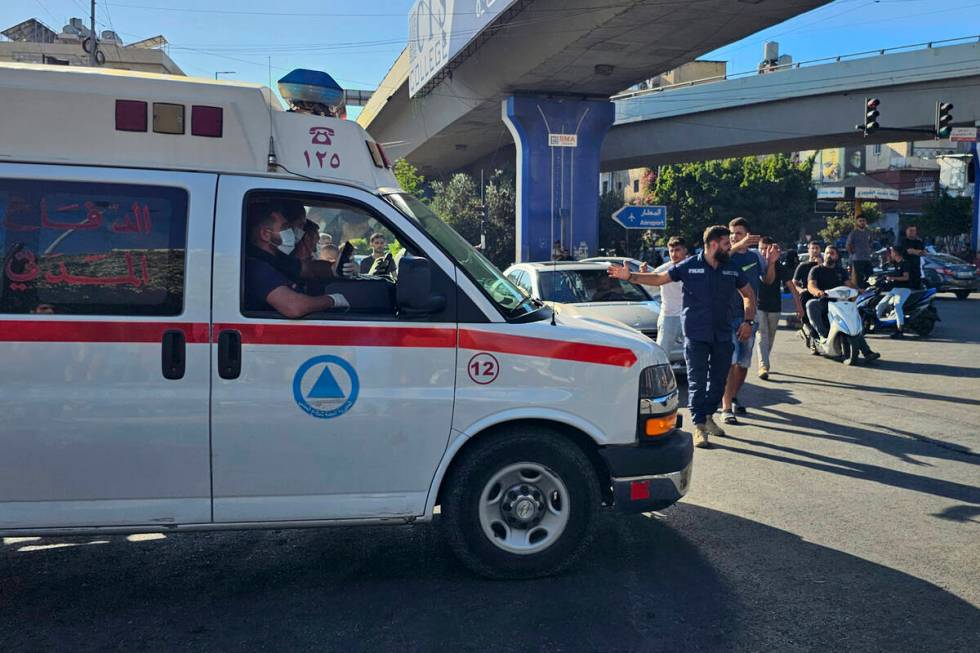 An ambulance carries wounded people whose handheld pager exploded, in Beirut, Lebanon, Tuesday, ...