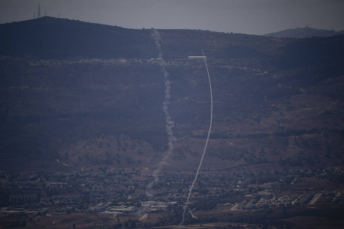 The Israeli Iron Dome air defense system fires to intercept an attack from Lebanon over the Gal ...