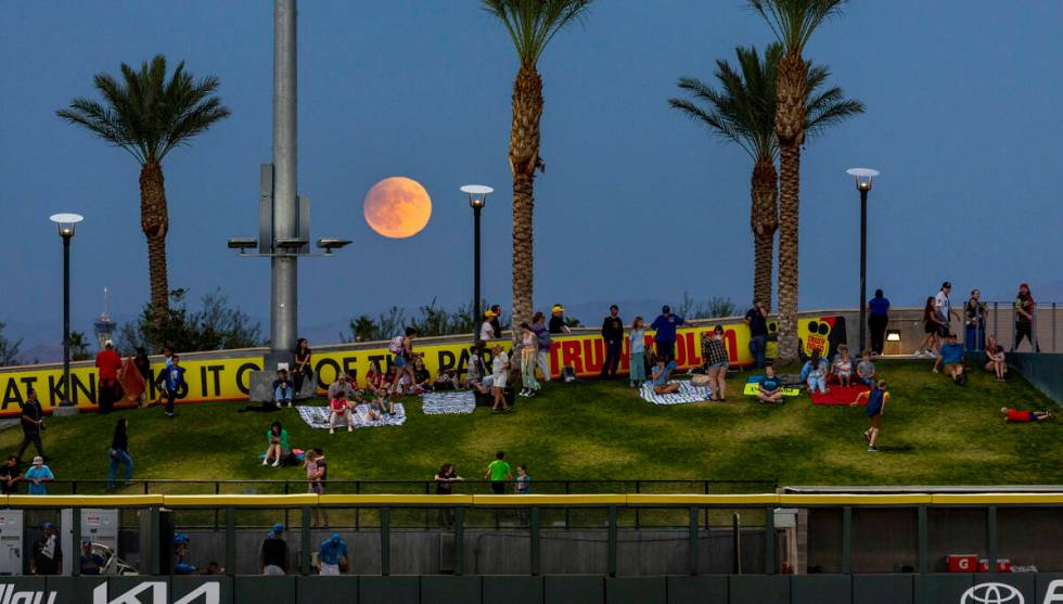 A Harvest Supermoon rises as fans gather on the berm for the Aviators against the El Paso Chihu ...